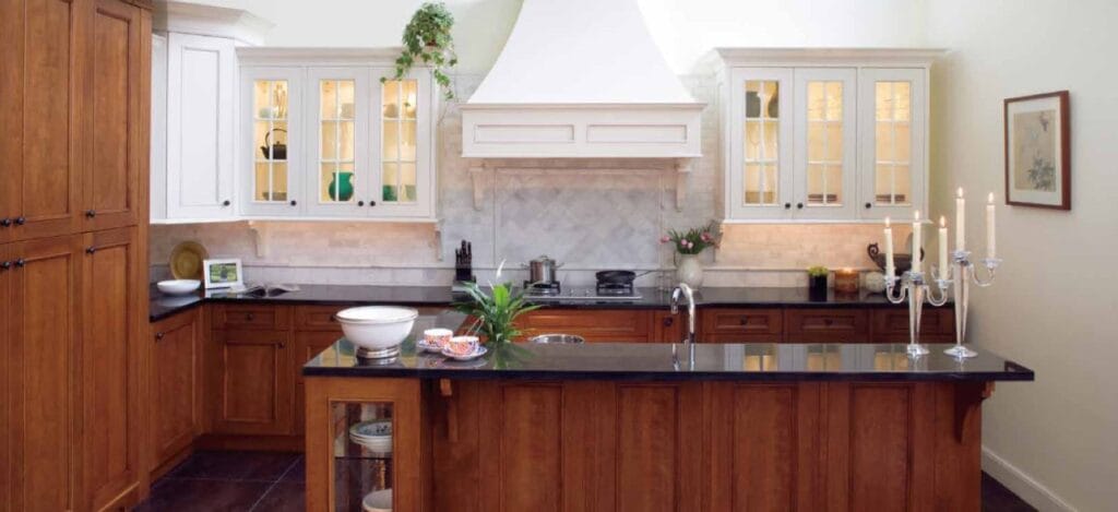 A modern kitchen featuring wooden cabinets and a sleek black countertop, showcasing a clean and organized space.