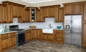 A modern kitchen featuring wooden cabinets and stainless steel appliances, showcasing a clean and organized space.