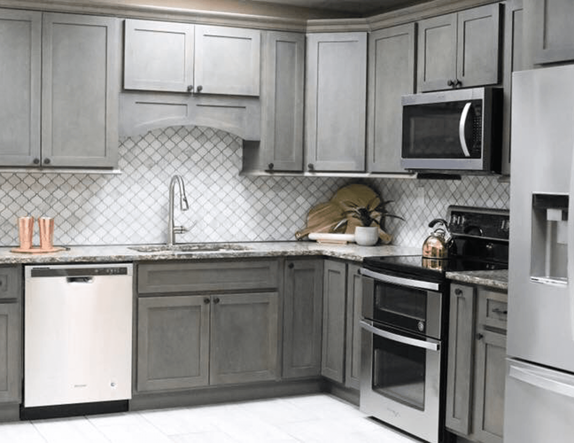 A modern kitchen featuring gray cabinets and stainless steel appliances, showcasing a sleek and contemporary design.